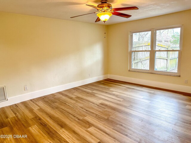 unfurnished bedroom featuring multiple windows, light hardwood / wood-style flooring, a closet, and ceiling fan