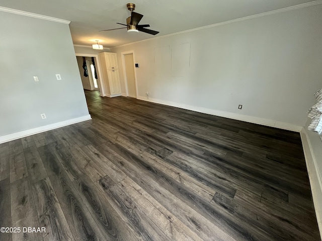 spare room with ceiling fan, baseboards, dark wood-type flooring, and crown molding