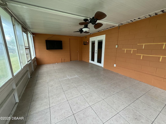 unfurnished sunroom with french doors and a ceiling fan