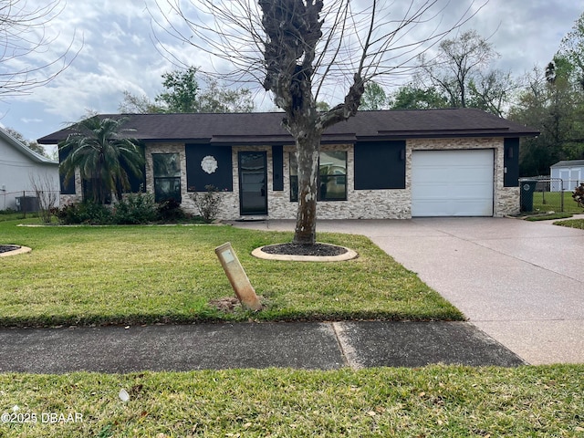 view of front of home featuring driveway, stone siding, an attached garage, fence, and a front yard