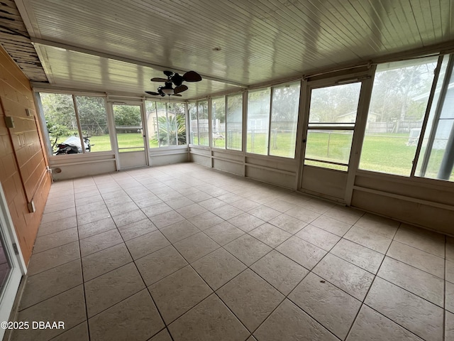 unfurnished sunroom featuring wood ceiling and ceiling fan