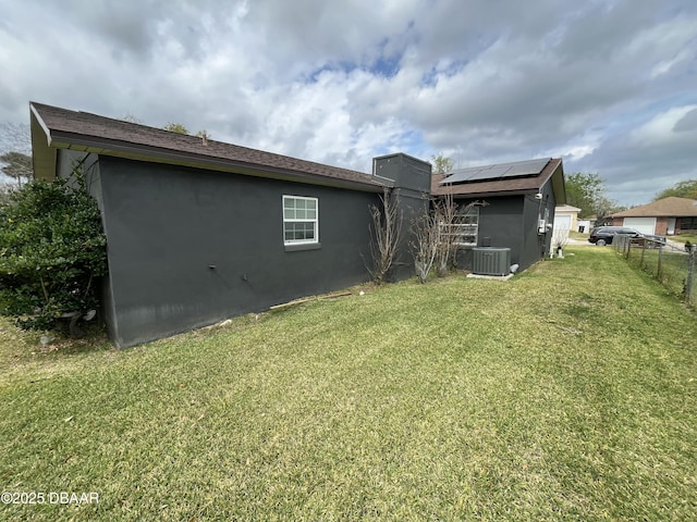 back of property featuring cooling unit, a lawn, fence, and stucco siding