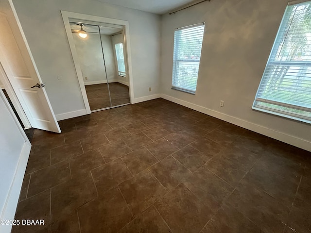 unfurnished bedroom featuring a closet and baseboards