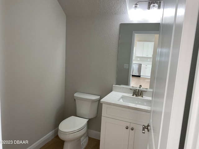 bathroom featuring vanity, hardwood / wood-style flooring, and toilet