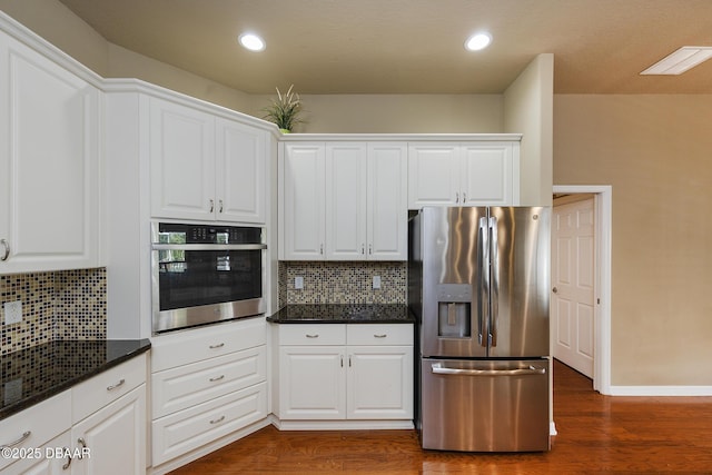 6065 Spruce Point Cir, Port Orange, FL 32128 - kitchen with stainless steel appliances, tasteful backsplash, dark wood-style flooring, white cabinets, and recessed lighting