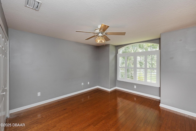 6065 Spruce Point Cir, Port Orange, FL 32128 - spare room featuring wood-type flooring, a ceiling fan, and a textured ceiling