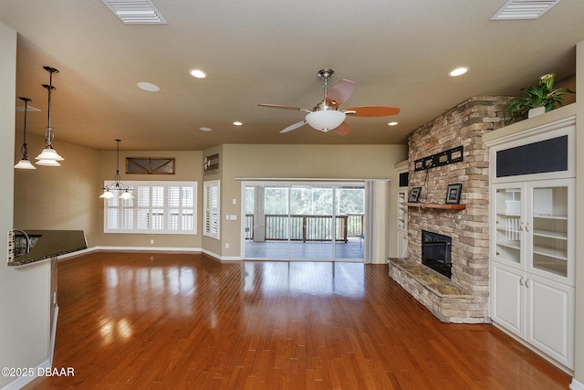 6065 Spruce Point Cir, Port Orange, FL 32128 - unfurnished living room with a ceiling fan, a fireplace, wood finished floors, and recessed lighting