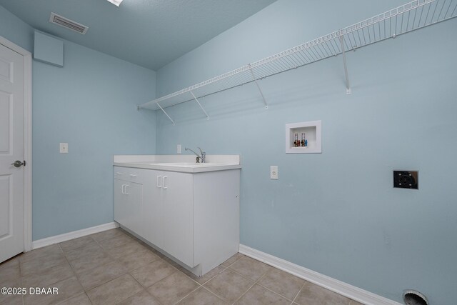 6065 Spruce Point Cir, Port Orange, FL 32128 - laundry area with hookup for a washing machine, light tile patterned floors, and cabinet space