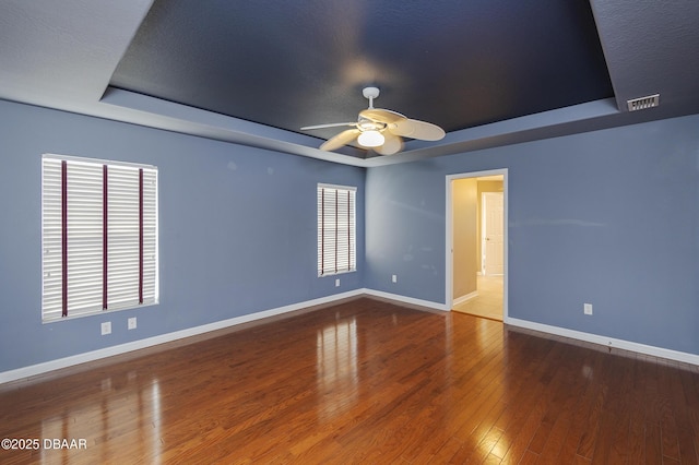 6065 Spruce Point Cir, Port Orange, FL 32128 - unfurnished room with a raised ceiling, ceiling fan, and hardwood / wood-style flooring