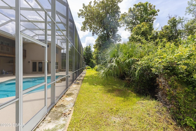 6065 Spruce Point Cir, Port Orange, FL 32128 - view of green lawn with an outdoor pool, glass enclosure, and a patio