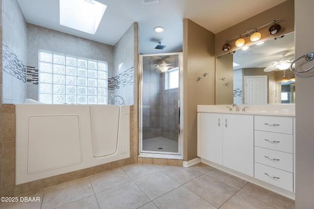 6065 Spruce Point Cir, Port Orange, FL 32128 - full bath featuring a shower stall, tile patterned flooring, vanity, a skylight, and a ceiling fan