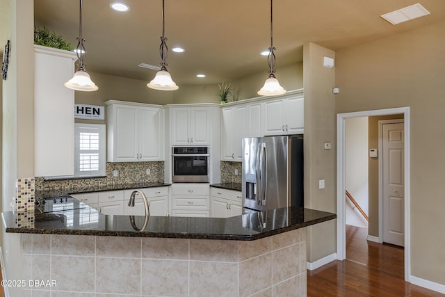 6065 Spruce Point Cir, Port Orange, FL 32128 - kitchen with appliances with stainless steel finishes, decorative backsplash, dark wood-style floors, white cabinets, and recessed lighting