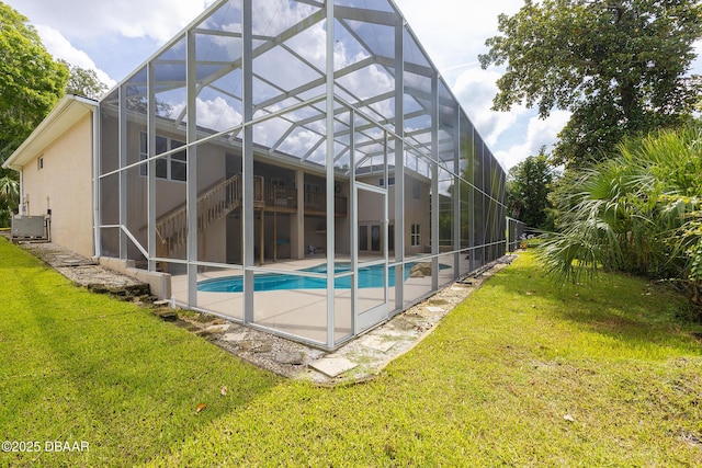 6065 Spruce Point Cir, Port Orange, FL 32128 - back of property with a lanai, stucco siding, a lawn, an outdoor pool, and a patio