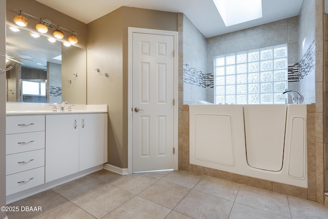 6065 Spruce Point Cir, Port Orange, FL 32128 - full bath with vanity, plenty of natural light, tile patterned flooring, and a skylight