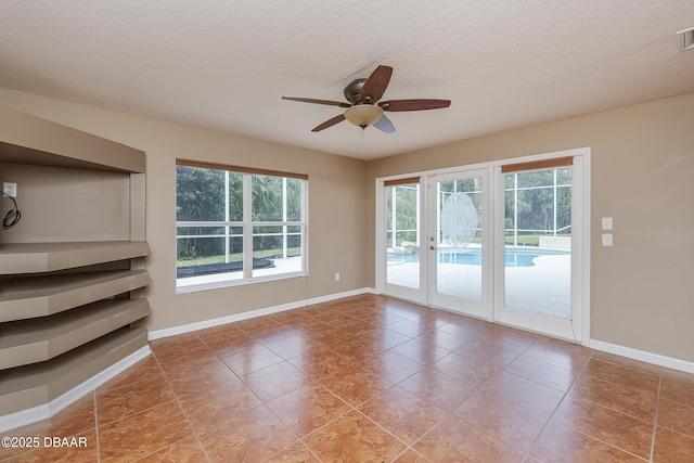 6065 Spruce Point Cir, Port Orange, FL 32128 - tiled empty room with a ceiling fan, french doors, and a textured ceiling