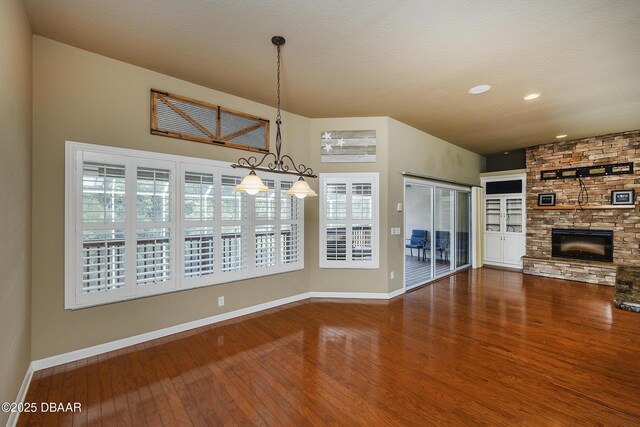 6065 Spruce Point Cir, Port Orange, FL 32128 - unfurnished dining area with wood finished floors, a fireplace, recessed lighting, and plenty of natural light
