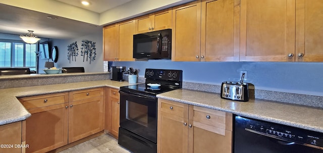 kitchen with light hardwood / wood-style floors, black appliances, and decorative light fixtures