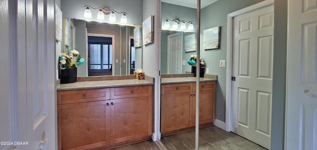 bathroom with vanity and hardwood / wood-style floors