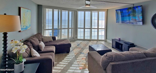 living room with hardwood / wood-style flooring, a textured ceiling, and ceiling fan