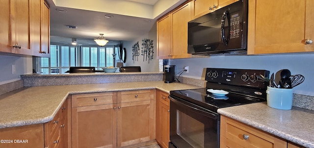 kitchen with kitchen peninsula and black appliances