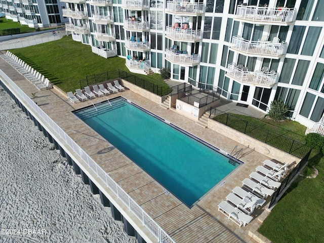 view of pool with a yard