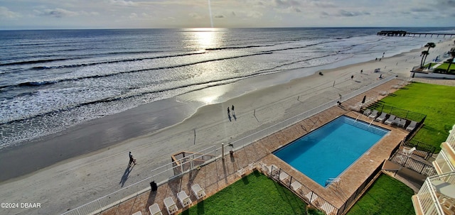 exterior space with a water view and a view of the beach