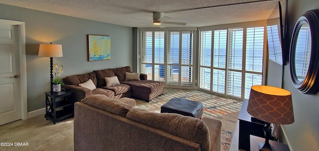 living room with light wood-type flooring, a textured ceiling, and ceiling fan