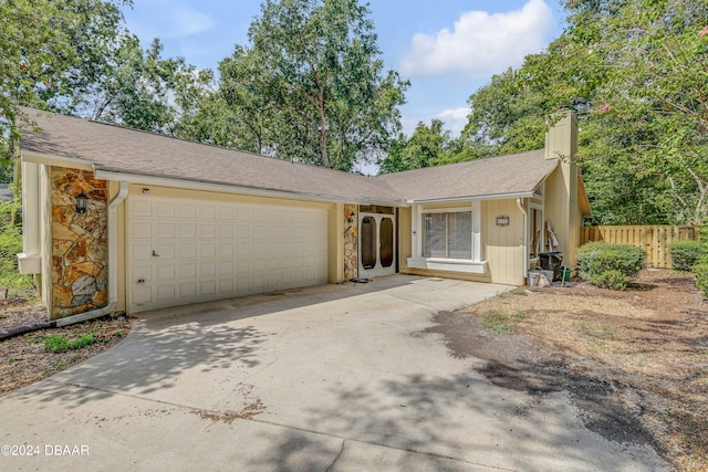 ranch-style home featuring a garage