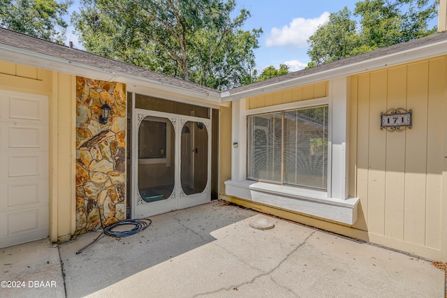 doorway to property with a patio area and a garage