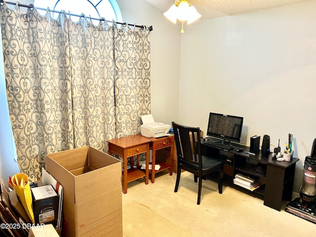 office area featuring light carpet and a textured ceiling