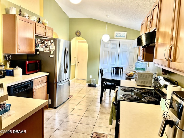 kitchen featuring light tile patterned floors, light countertops, hanging light fixtures, appliances with stainless steel finishes, and vaulted ceiling