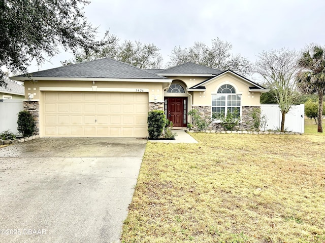 ranch-style home with stone siding, an attached garage, concrete driveway, and stucco siding