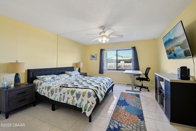 bedroom with ceiling fan, a textured ceiling, and light tile patterned floors