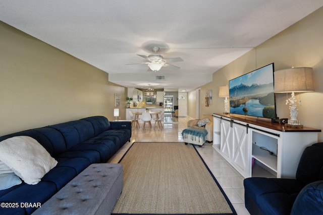 living room featuring light tile patterned flooring and ceiling fan