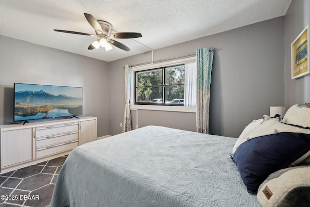 bedroom with a textured ceiling and ceiling fan