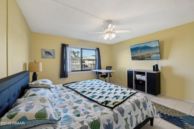 bedroom featuring light tile patterned flooring, a textured ceiling, and ceiling fan