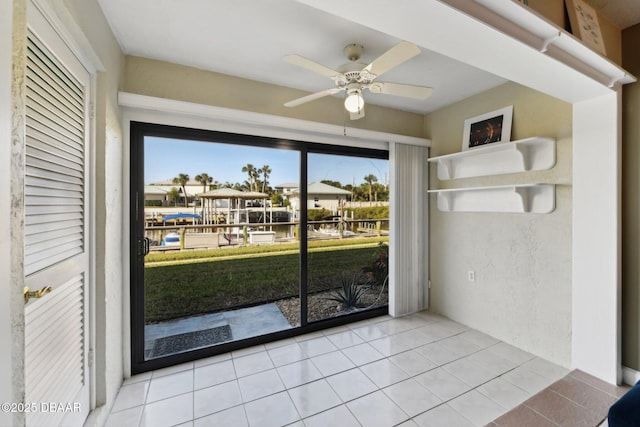 interior space with ceiling fan