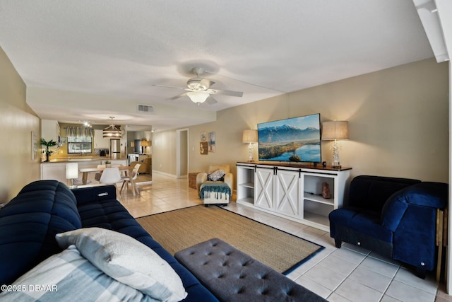 tiled living room with ceiling fan