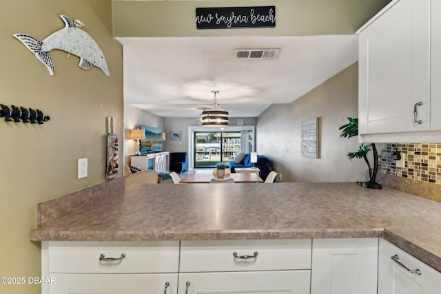 kitchen with white cabinetry and decorative backsplash