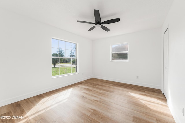 unfurnished room with light wood finished floors, ceiling fan, and baseboards