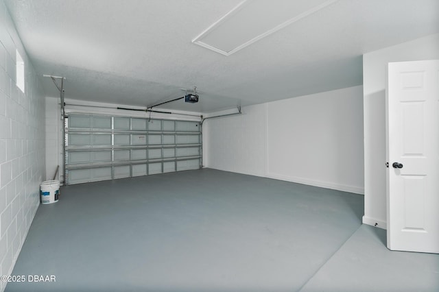 garage with concrete block wall and a garage door opener