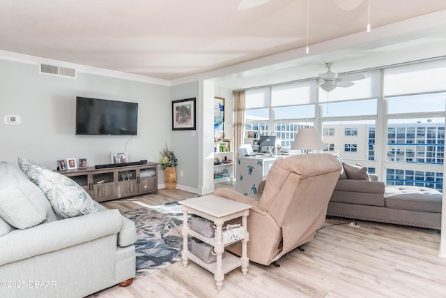 living room featuring ceiling fan, light hardwood / wood-style flooring, and crown molding