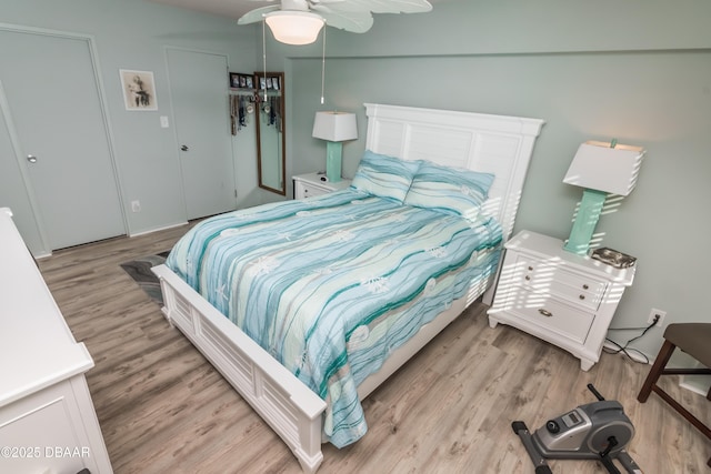 bedroom with light hardwood / wood-style flooring and ceiling fan