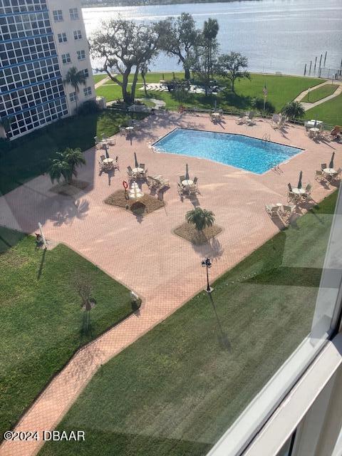 view of swimming pool with a water view