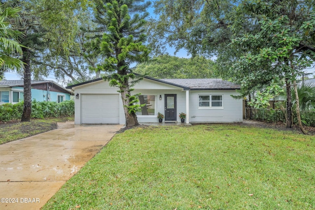 single story home featuring a garage and a front yard