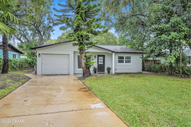 view of front of house featuring a garage and a front lawn