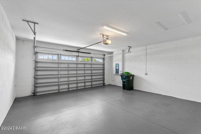 garage featuring a garage door opener and electric panel