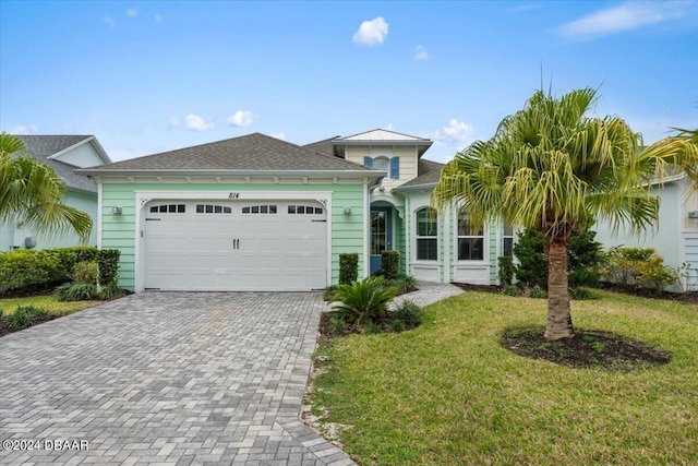 view of front of house with a front lawn and a garage