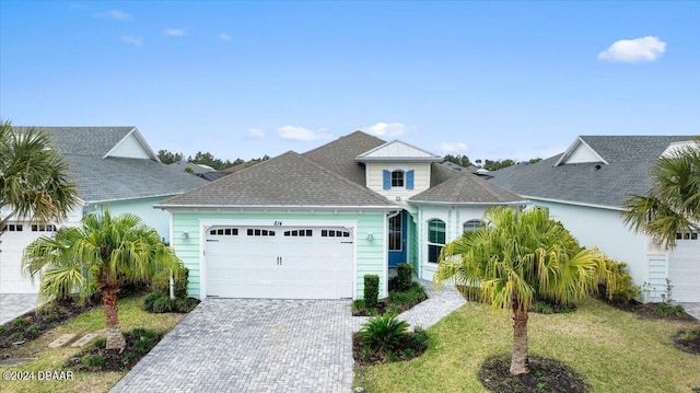 view of front of property with a garage and a front lawn