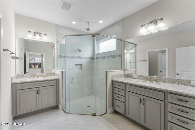 bathroom featuring vanity, a wealth of natural light, tile patterned flooring, and walk in shower